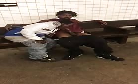 Two homeless black men having oral fun at a subway station