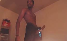 Horny nigga stroking his long oiled cock